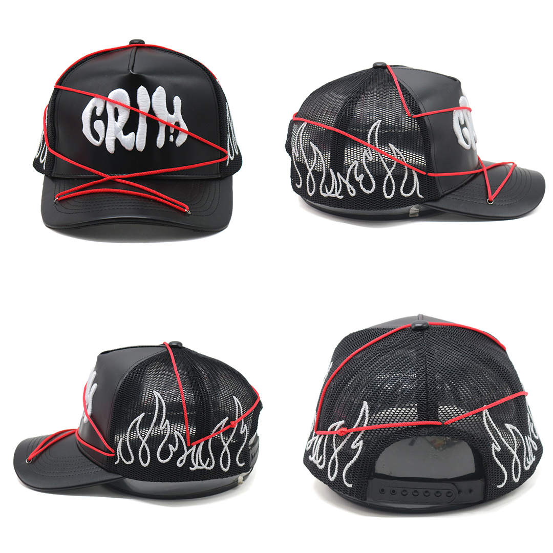 A black cap with red embroidery in the shape of flames and the text 'GRIM'. It has an adjustable red strap and a leather insert on the front.